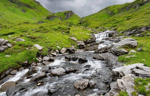 Bergbach Sousbach flows through picturesque green mountain landscape, long exposure, Bernese Alps,