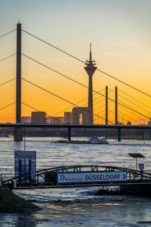 Sunset on the Rhine near Düsseldorf, skyline of the city centre with Rhine Tower, Rheinkniebrücke,