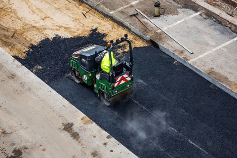 Tandem roller compacts an asphalt surface following road repair, Schöneberg, Berlin, Germany