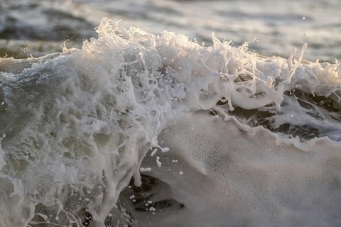 Surf, breaking wave against light, Sortebærdalen Strand, Houvig, North Sea, Denmark