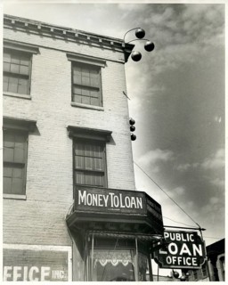 Money to Loan, pawnshop, loan office, USA, small town, traditional signs on the house, 3 bullets,