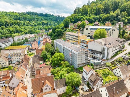 Urban landscape with hills rich in vegetation and dense buildings, new PV plant at