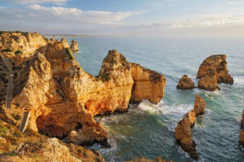Ponte da Piedade sea stacks in Lagos, Algarve, Portugal, at sunrise with Atlantic ocean, cliffs,