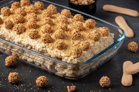Finished tiramisu in glass shape decorated with hazelnut balls