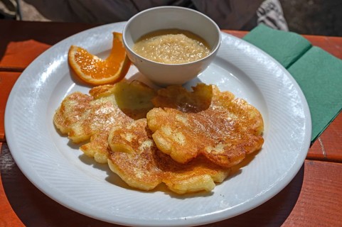 Baggers serving potato pancakes with applesauce in a garden restaurant, Franconia, Bavaria, Germany