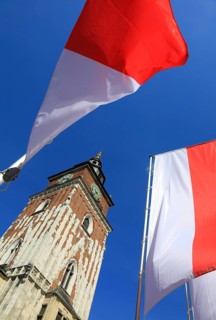 Town Hall Tower on the Main Market Square in Krakow, surrounded by Polish national colors, flags,