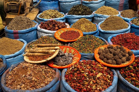 Dried scented flowers, spices and medicinal herbs for sale are on display at a sales stand, spice