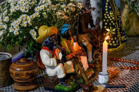 Altar with candles and flowers in homage to the Old Black Man inside an Umbanda temple, Belo