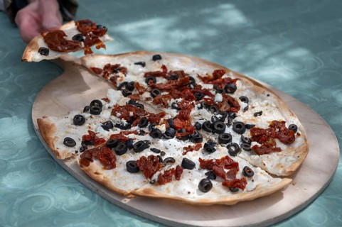 Flammkuchen, Mediterranean served on a wooden board, Franconia, Bavaria, Germany