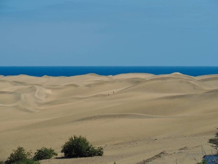 Infinite sand stretches to the blue sea, dunes of Maspalomas, Gran Canaria, Spain