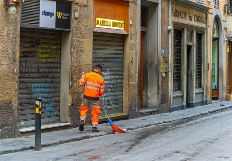 City cleaning workers wearing orange-colored protective clothing working in the city in the