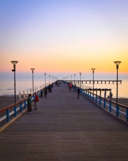 Dramatic colorful sunset at famous marine pier in Baltic resort city of Palanga. Lithuania