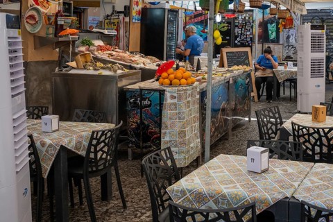 View of a food stand with tables, Palermo, Sicily, Italy