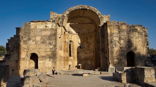 Titus Basilica, Greece, large ancient stone structure with archway against blue sky, Gortyn,