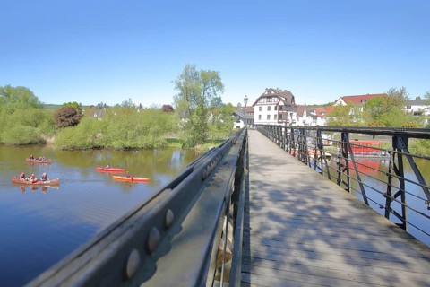 Zweipfennigbrücke built in 1890 across the river Fulda with canoeists, kayaks, footbridge,