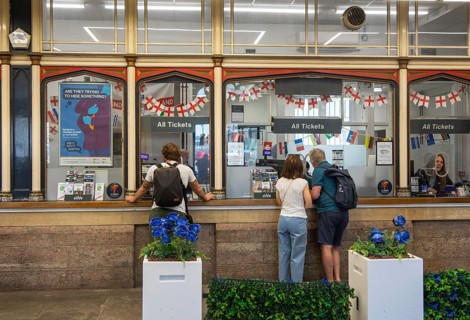 People at Ticket Office sales and information booths, Temple Meads railway station, Bristol,