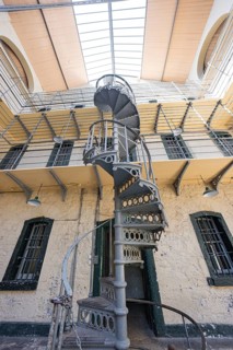 Close-up of a metal spiral staircase up to gallery levels in an old building, Kilmainham Gaol