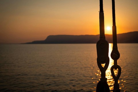 Part of the rigging of a sailing ship, anchoring, steel cables, back light, sunset, silhouette,