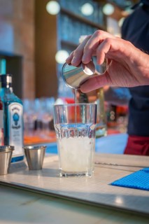 A drink is being prepared in a glass, with bottles in the background, Hochzeit, Grossglattbach,