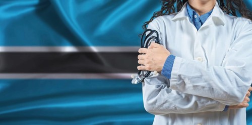 Healthcare professional with Botswana flag background. Professional doctor holding stethoscope on