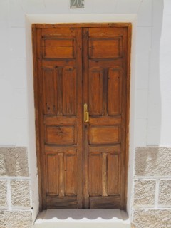 Rustic wooden door with golden door handle in white facade, Fataga, Barranco de Fataga, Gran