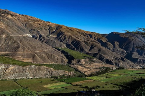 Cordillera Negra mountain range with fields in the valley floor, Black Cordillera, northern Peru,