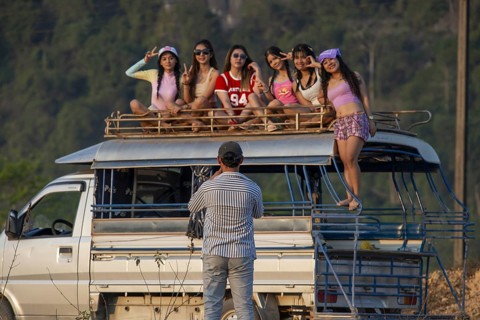 Photo shoot with young girls in the karst landscape near Vang Vieng, Vientiane province, Laos