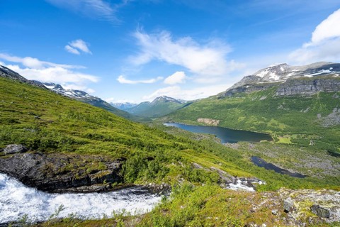 View of Innerdalen high valley with mountain landscape and lake Innerdalsvatna, waterfall on the