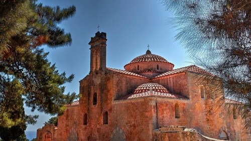 Metamorphosi tou Sotiriou Church, An old brick church surrounded by trees under a clear sky with