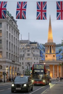 Red double-decker bus and taxi in front of All Souls Langham Place, Church of John Nash and BBC