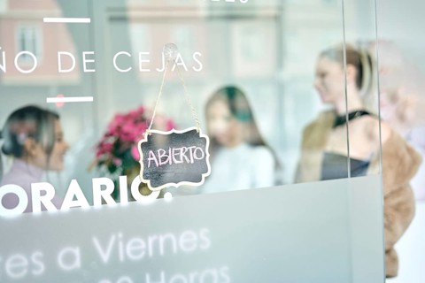 Skilled beauty professionals attend to clients in a modern salon, creating a vibrant atmosphere.