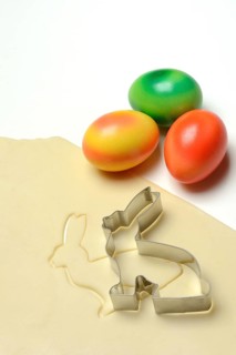 Rolled dough with bunny cookie cutter and easter eggs