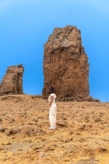 Young tourist admiring the roque nublo, a volcanic rock formation in the tejeda municipality of