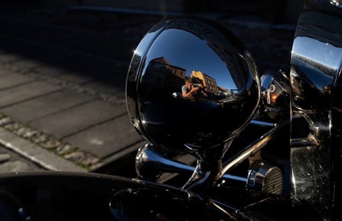 Photographer reflected in the headlights of a vintage Mercedes-Benz 500 K Special Roadster 1936