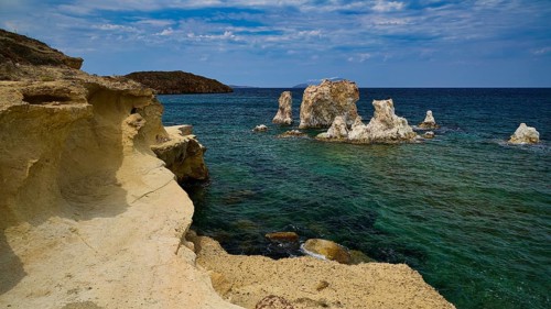 Dramatic rocky coast with turquoise sea under a cloudy sky, Aspragremna, White Cliffs, Mavorspilia