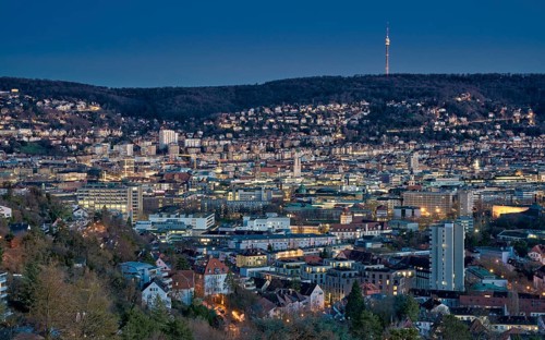 Panoramic night view of Stuttgart city center in Germany with glowing city lights, dense urban