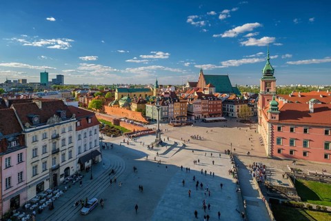 High angle view of Warsaw Old Town and Castle Square with pedestrians, red rooftops, Sigismunds