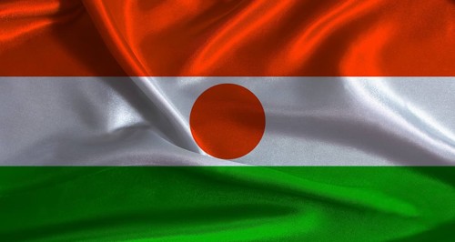 Niger flag with cloth textured background. National flag of Niger with realistic texture
