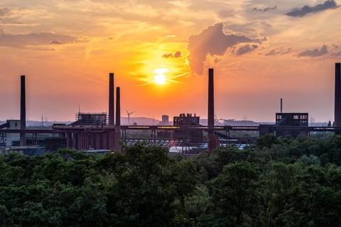 Sunset over the Zollverein coal mine coking plant, UNESCO World Heritage Site, chimneys and band