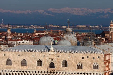 Doge's Palace and domes of St. Mark's Basilica in front of the snow-capped Alps, Venice, Veneto,