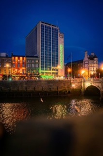 Night view of illuminated city with prominent building and river, Heinecken, Dublin, Ireland