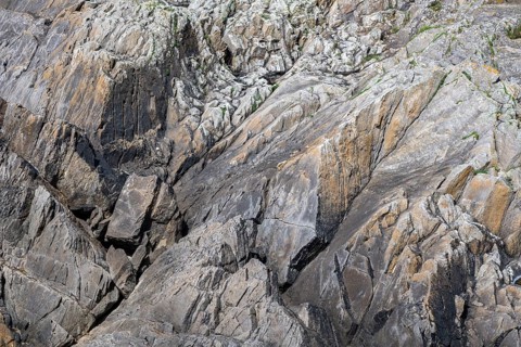 Rocks, heavily rugged rock structure, slate, filling formats on the coast of Cape Pointe