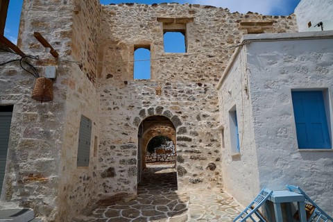 Passage to Kastro, stone building with window, traditional arch in an old quarter, main town in