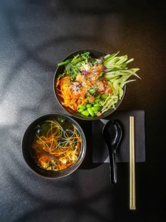 Japanese-style lunch. Bowl with fresh salmon, carrots, cucumbers, green beans, chukka lettuce.