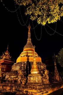Gilded and illuminated Chedi Temple Tower, stupa, night view, Old City Center, Chiang Mai, Thailand
