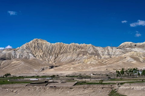 Mountainous landscape, erosion landscape and cultivated fields near Lo Manthang, Mustang, Upper