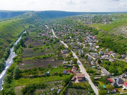 Rural settlement with a river and green hills in the area, aerial view, view of Trebujeni, Raut