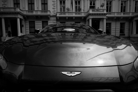Logo, Aston Martin sports car parked in front of IMPERIAL College, University and Technical