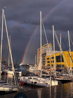 Marina with sailboats and rainbows against dark grey sky, Kalmar, Kalmar Län, Sweden
