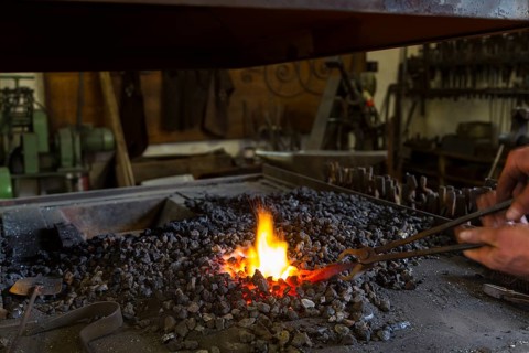 A blacksmith forging, working at the Ehnert forge in Dresden-Bühlau, Saxony, Germany